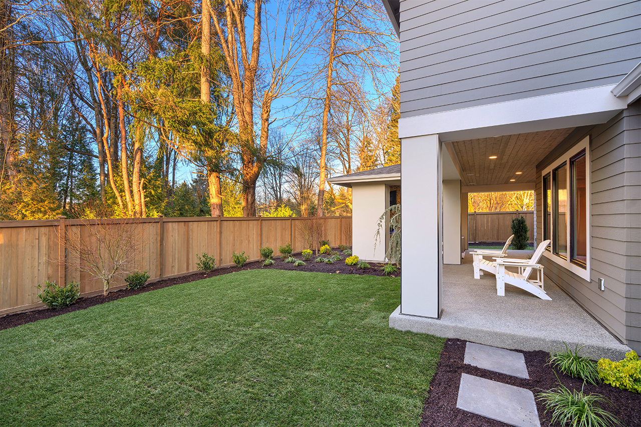 grey house with fenced backyard