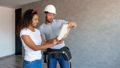 A woman talking to a contractor about house’s plans