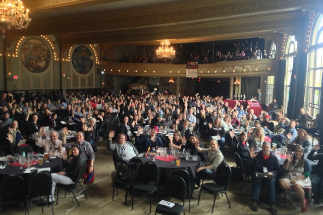 Attendees waving to the camera