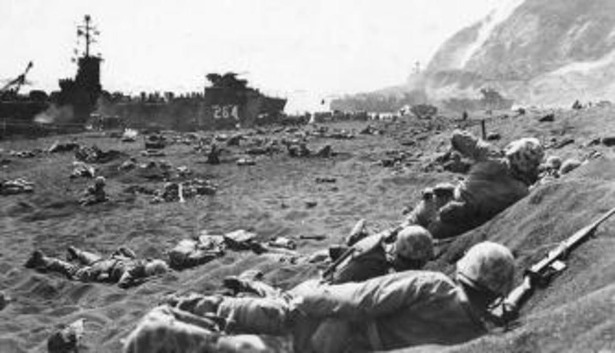 U.S. Marines take cover on the beach at Iwo Jima