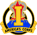 A gold device containing a gold letter I superimposed over an erupting volcano, with the words "America's Corps" at the bottom