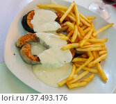 Tasty fried salmon with white sauce and french fries potatoes on plate. Стоковое фото, фотограф Яков Филимонов / Фотобанк Лори