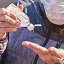 Man wearing mask uses antibacterial gel on hands, closeup. Стоковое фото, фотограф Kira_Yan / Фотобанк Лори