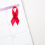 Red awareness ribbon marking world aids day. Стоковое фото, агентство Wavebreak Media / Фотобанк Лори