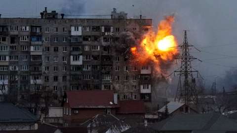 An explosion is seen in an apartment building after Russian's army tank fires in Mariupol, Ukraine, Friday, March 11, 2022.