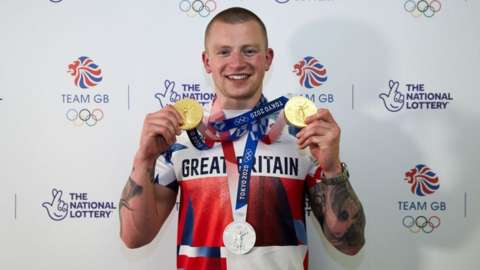 Adam Peaty with gold medals