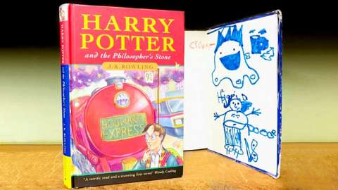 A first-edition Harry Potter book with a child's drawings inside the front cover