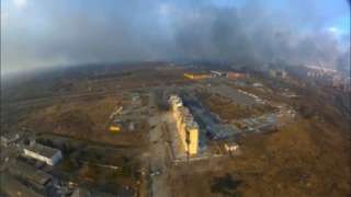 An aerial view shows smoke rising from damaged residential buildings following an explosion, amid Russia"s invasion of Ukraine, in Mariupol, Ukraine March 14, 2022 in this still image taken from a drone footage obtained from social media.