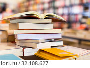 stack of books lying on table in bookstore. Стоковое фото, фотограф Татьяна Яцевич / Фотобанк Лори