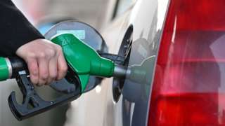 A woman fills up her car with diesel at a petrol station in Mulhouse, eastern France, on March 8, 2022.