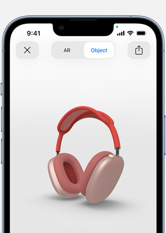 Slika na kojoj se prikazuju ružičaste AirPods Max slušalice na zaslonu Proširena stvarnost na iPhone uređaju.