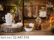 Christmas decoration cocoa bar with cookies and sweets on old wooden background in natural rustic style. Winter cozy concept. Стоковое фото, фотограф Майя Крученкова / Фотобанк Лори