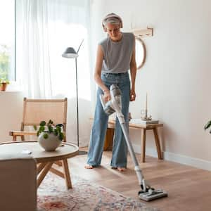 Housewife cleaning floor in living room