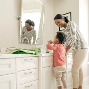 A mother with her daughter brushing her teeth