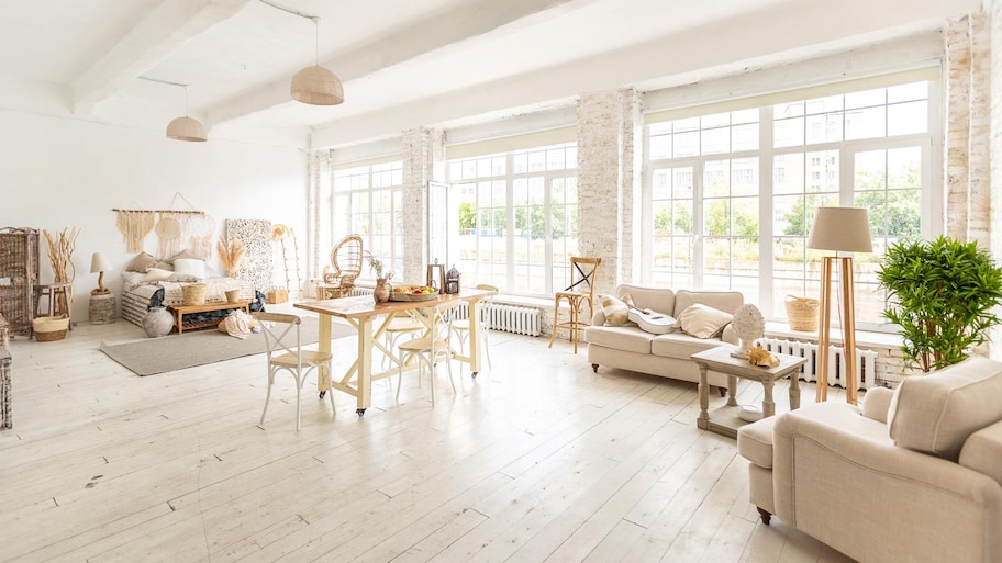 A spacious room resembling a loft with large windows