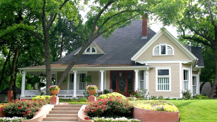 Suburban house exterior with big tree in the front yard