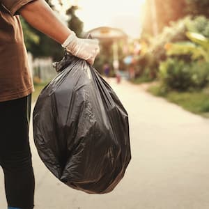 Man removing waste in trash back