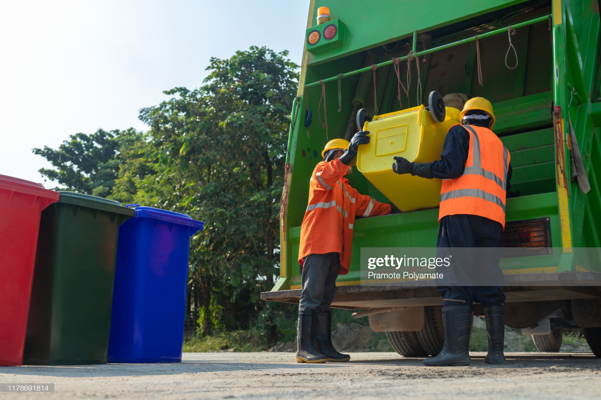 Two workers of a garbage collector truck