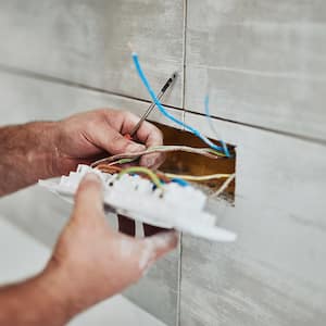 Electrician fixing wires of an outlet