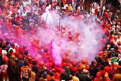 People covered in coloured powder celebrating Holi