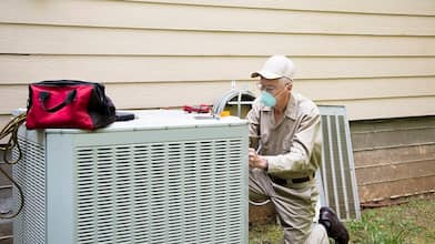 Man fixing air conditioner unite