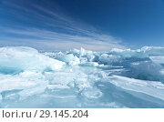 Layered clouds over the ice hummock field. Cold blue natural background. Lake Baikal In winter. Стоковое фото, фотограф Виктория Катьянова / Фотобанк Лори