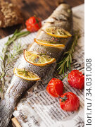 Oven-baked Sea bass with lemon and herbs. fish, baked entirely. Стоковое фото, фотограф Nataliia Zhekova / Фотобанк Лори