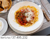 Spaghetti bolognese with grated Parmesan and aromatic dried herbs. Стоковое фото, фотограф Яков Филимонов / Фотобанк Лори