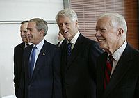 Carter, George H. W. Bush, George W. Bush, and Bill Clinton standing next to each other.