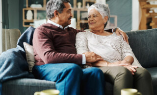 Couple sitting on couch together smiling