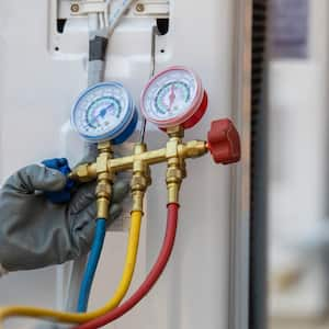 A technician checking new air conditioner