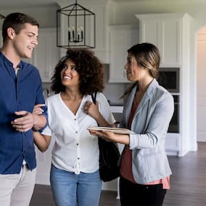 realtor showing couple apartment