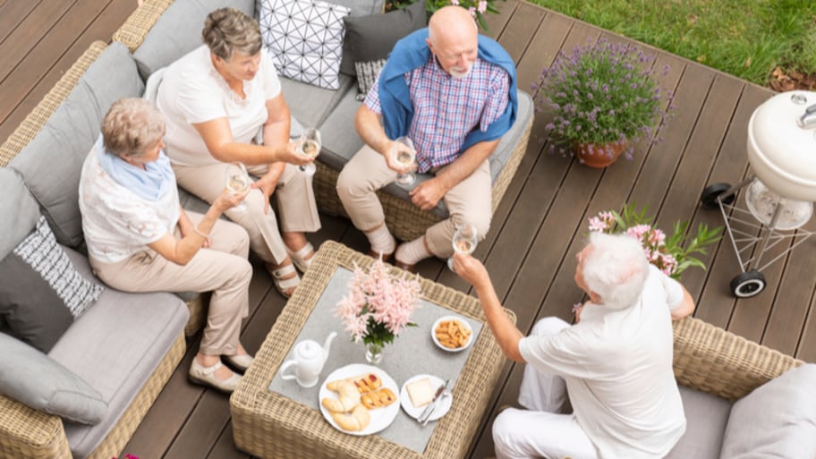 Group of friends sitting on deck with wine glasses