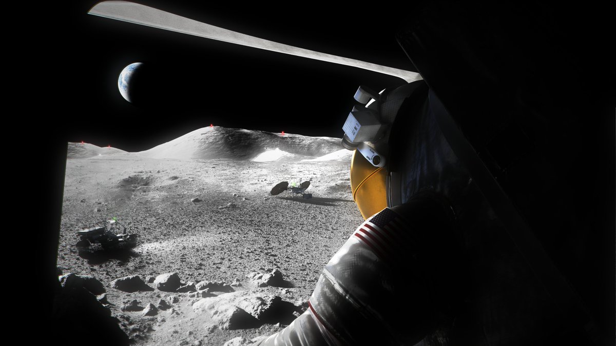 An astronaut steps out of the shadow of a lander and looks out at the Moonscape before them. There is a lunar rover in the foreground. The Earth can be seen in the black sky. 