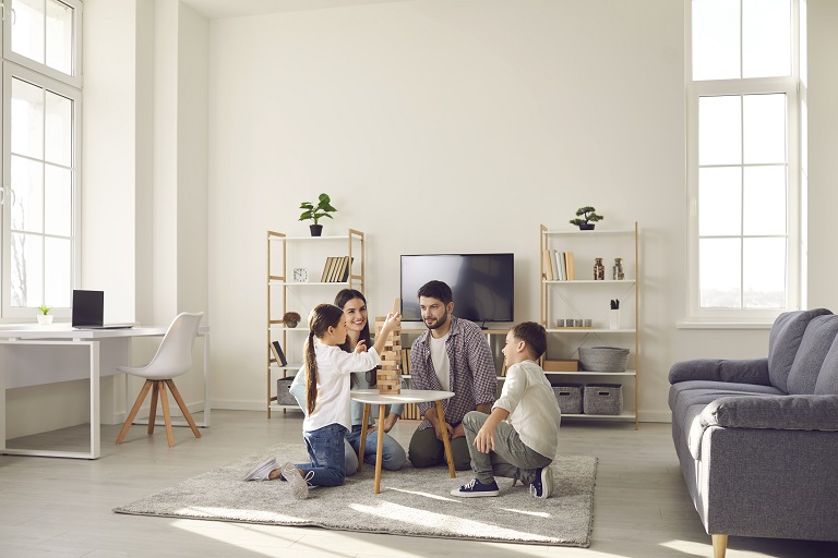 Family playing on floor in living room