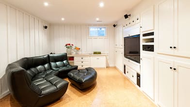 Basement white cabinet black couch