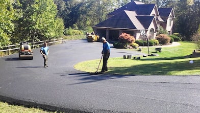 asphalt contractors paving a driveway