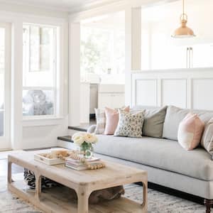 A bright living room with neutral tones and white walls