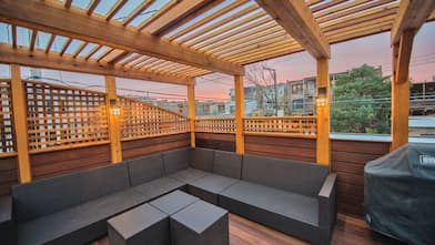 stained deck with lattice walls pergola and sectional outdoor couch