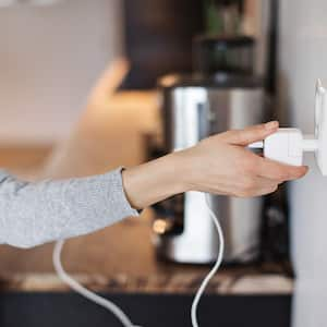 woman charging her phone in outlet