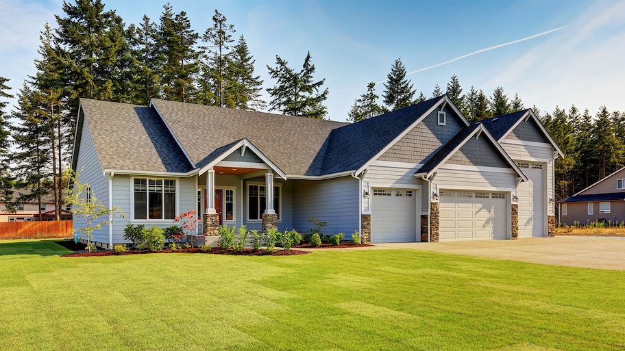 blue suburban home with yard space