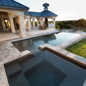 Spa and lap pool with stone patio