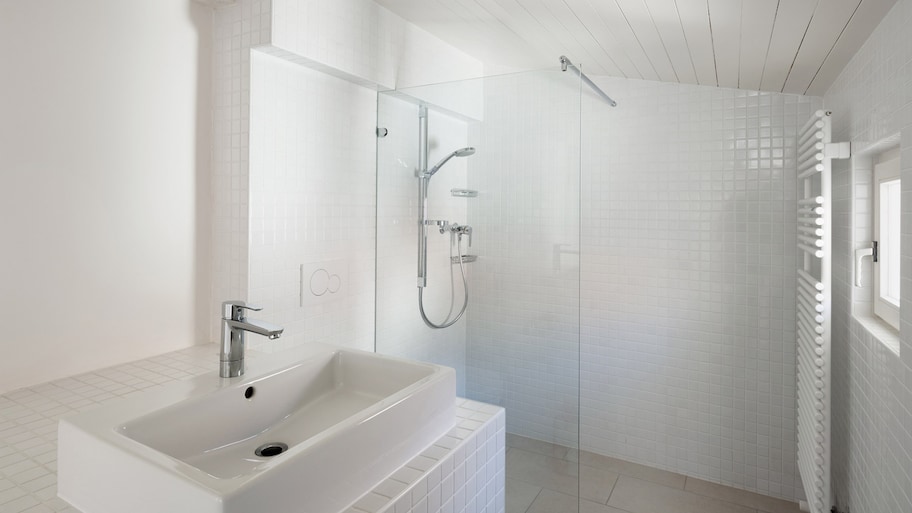 A bright shower cabin with tiles