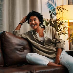 A young woman sitting on the leather sofa