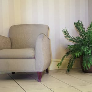 a tan fabric chair with a house plant