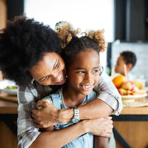 Happy mother and children in the kitchen