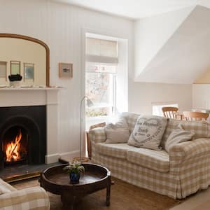 An open-plan sitting and dining area in a cottage house