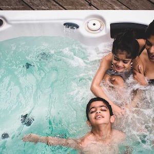 A family relaxes in a hot tub