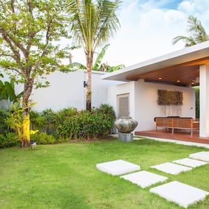 The exterior of a modernist home with a beautiful garden