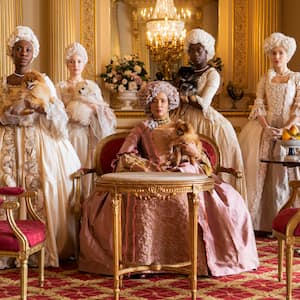 Bridgerton women in period costume standing in ornately decorated room